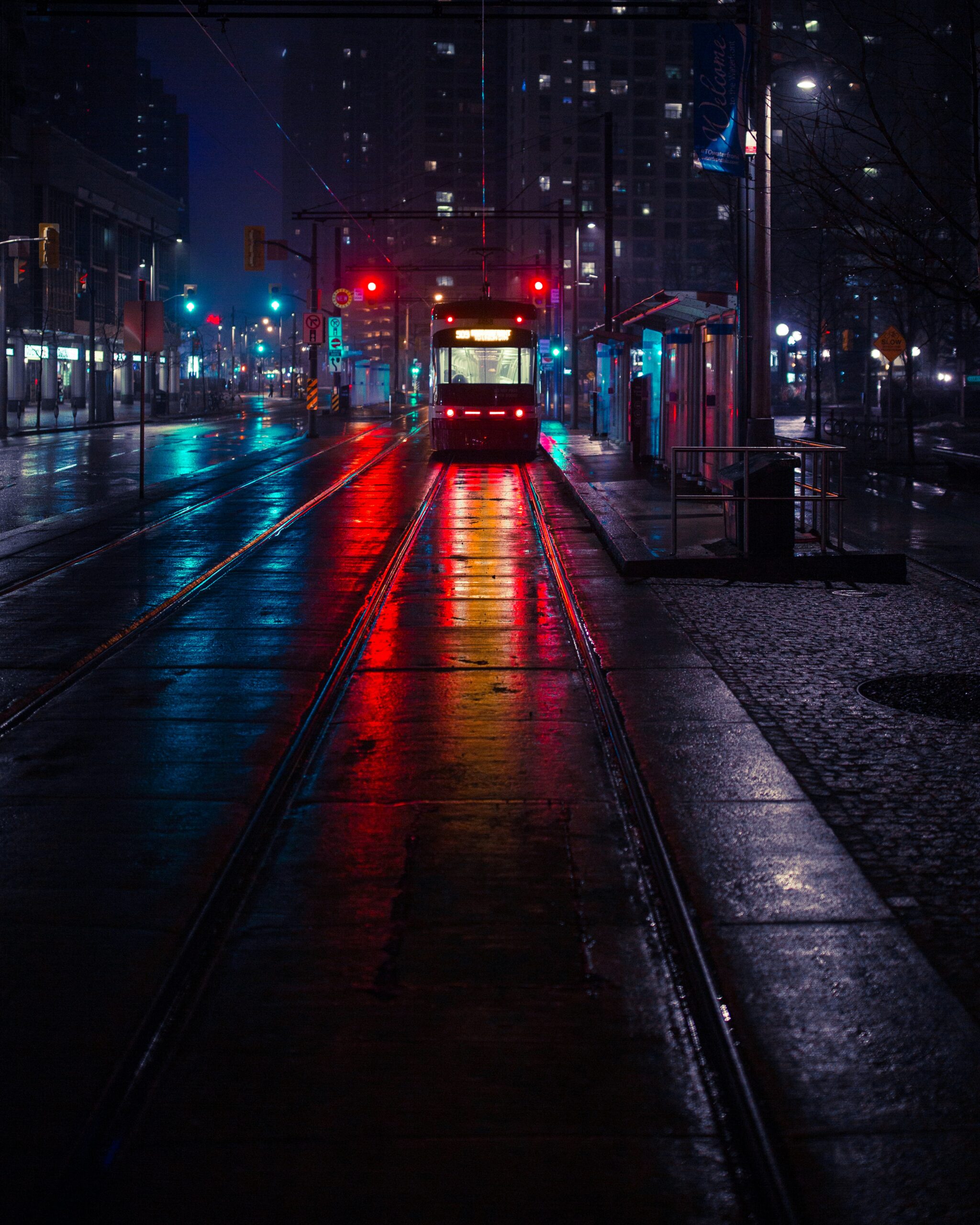 A train on a city street at night.